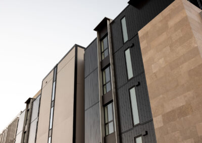 AliClad Max in ironsand matt, FR doors and windows, curtain wall, flashings, louvres and fins.
